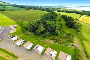 Aerial of the fully serviced hardstanding touring pitches with elevated views