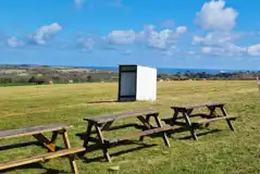 Non electric grass pitches with Falmouth Bay views and communal picnic benches