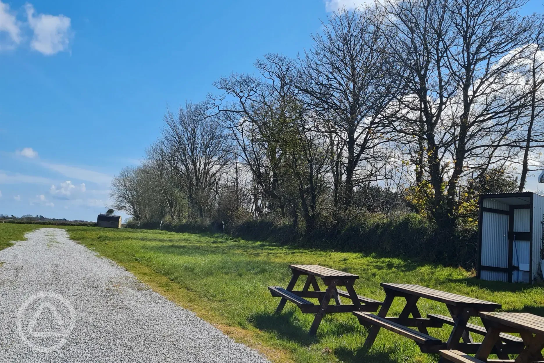 Electric grass pitches near communal picnic benches