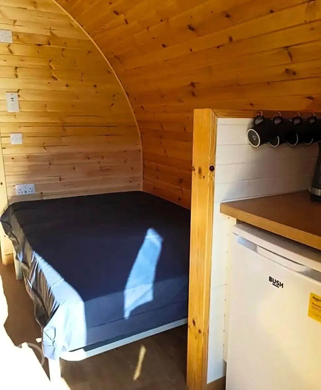 Large hiker pod with sofa bed interior with fridge, mugs, kettle and microwave