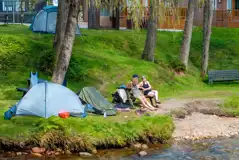 Non electric grass tent pitches by the river