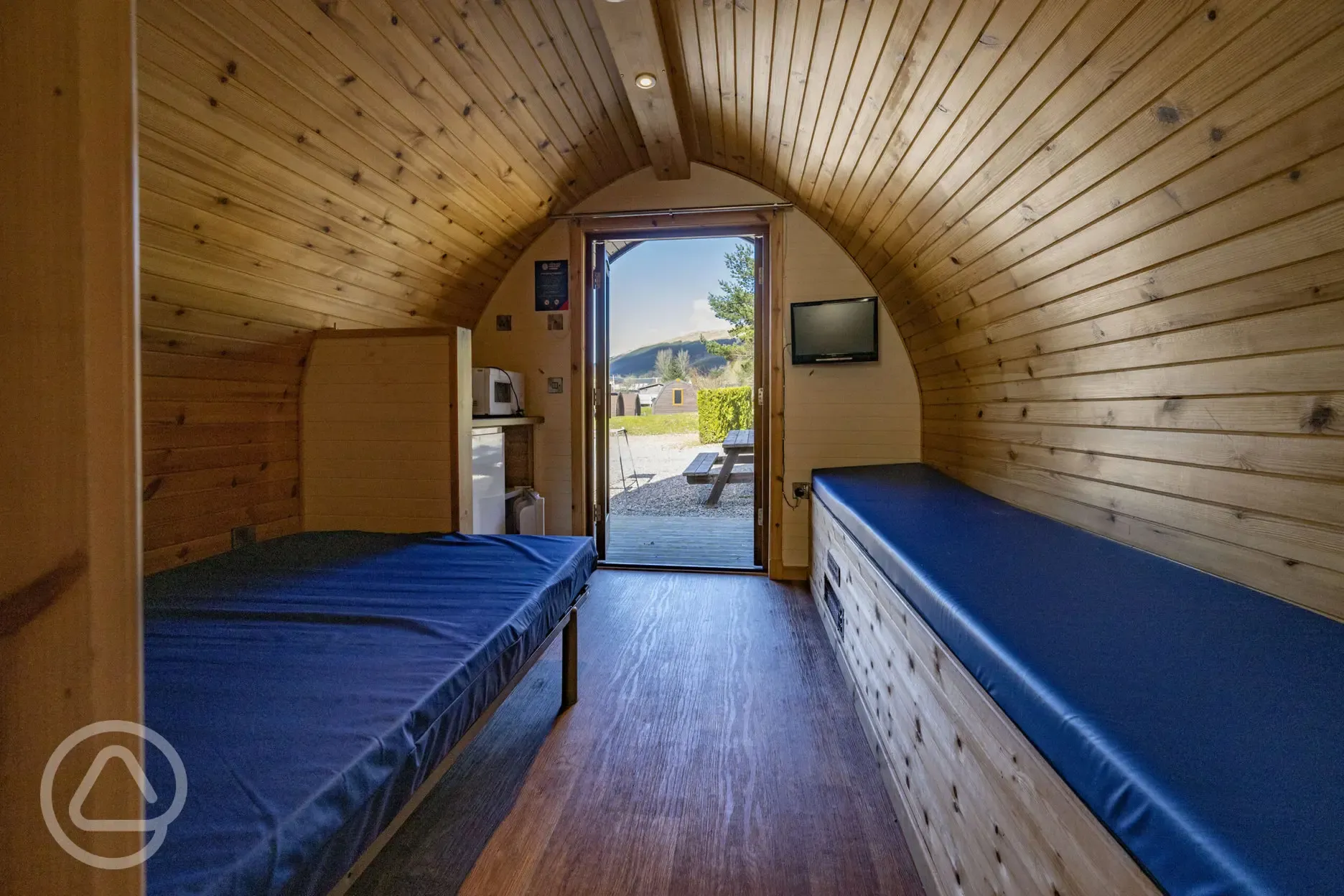 Small ensuite hiker pod interior with TV and mountain views