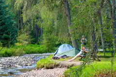 Non electric grass tent pitches by the river