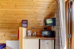 Large hiker pod with sofa bed interior with fridge, mugs, kettle and microwave
