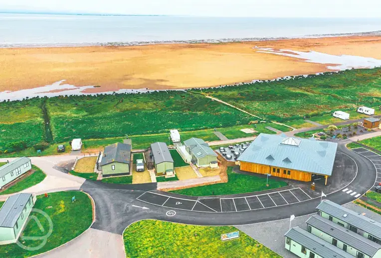 Aerial of Queensberry Bay with distant views of Powfoot Beach