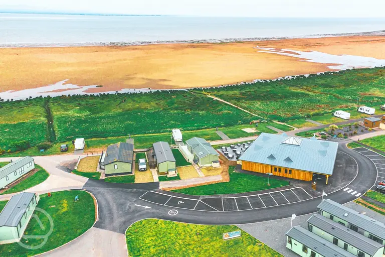 Aerial of Queensberry Bay with distant views of Powfoot Beach