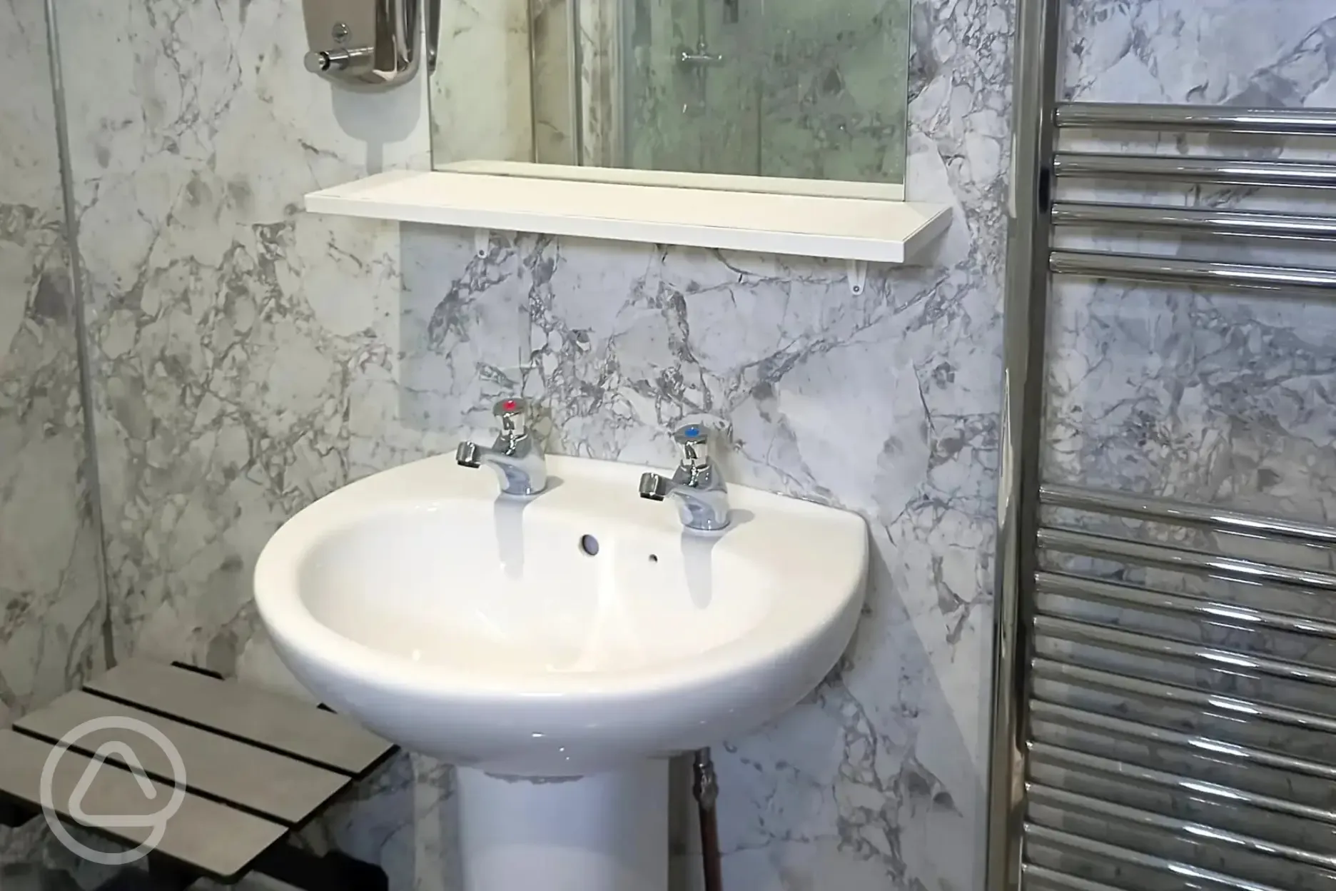 Handwashing sink next to towel rack in the facility block 