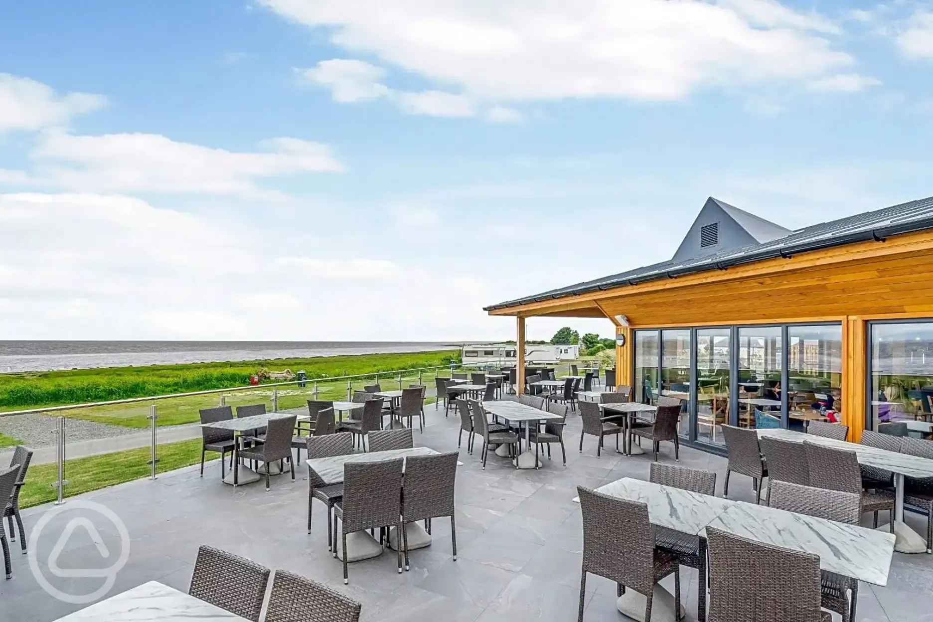 Outdoor seating at Sandpiper Cafe Bar with distant sea views