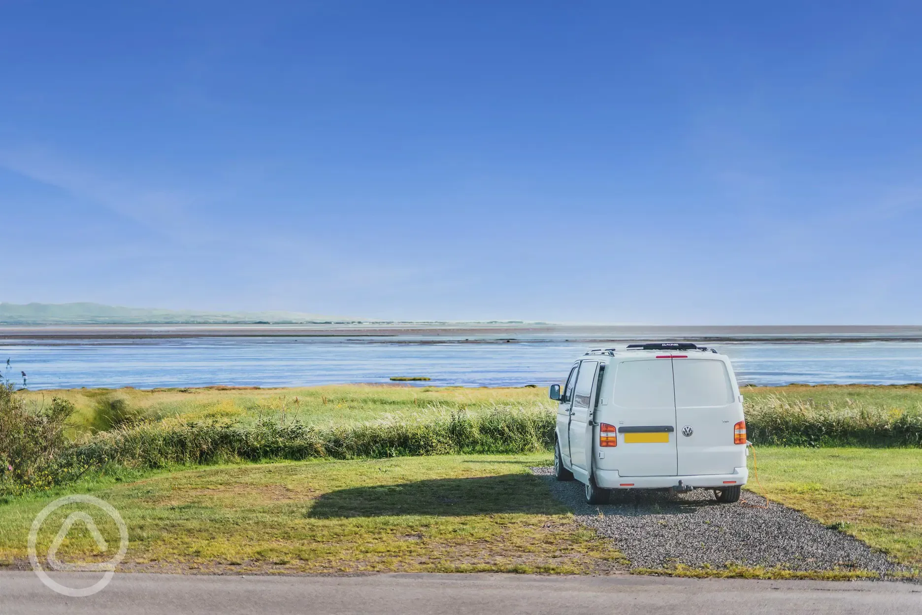 VW campervan on the sandside electric hardstanding touring pitch with sea views