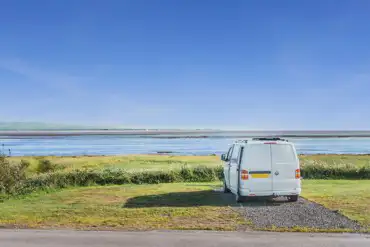 VW campervan on the sandside electric hardstanding touring pitch with sea views