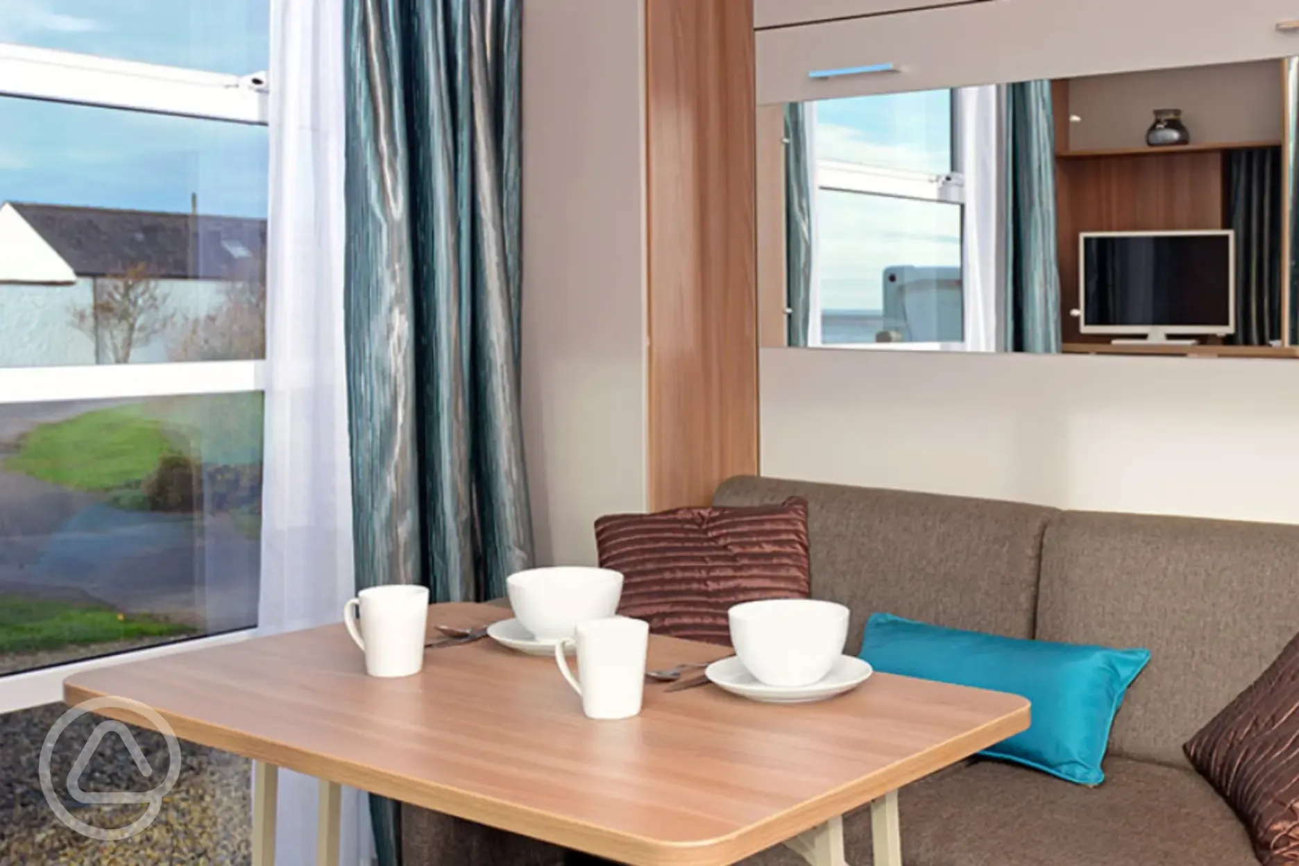 Sofa and dining area in ensuite glamping cabin