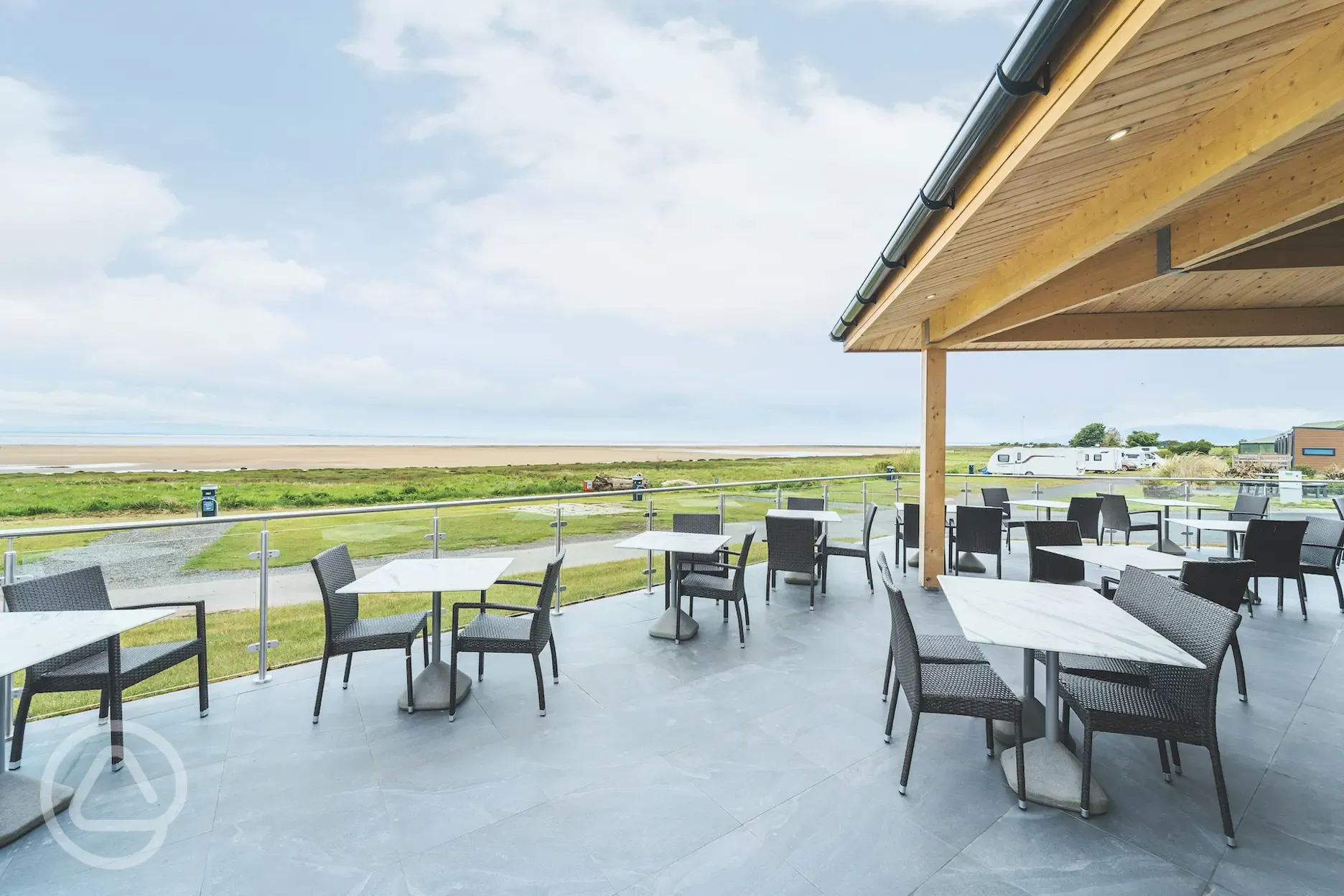 Outdoor seating at Sandpiper Cafe Bar with distant sea views