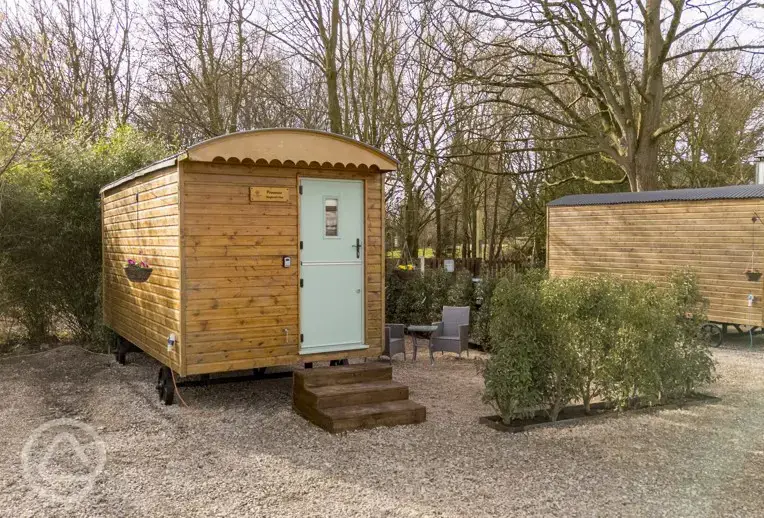 Shepherd's hut exterior with outdoor seating