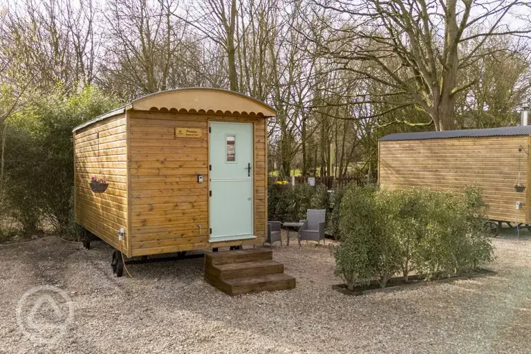 Shepherd's hut exterior with outdoor seating
