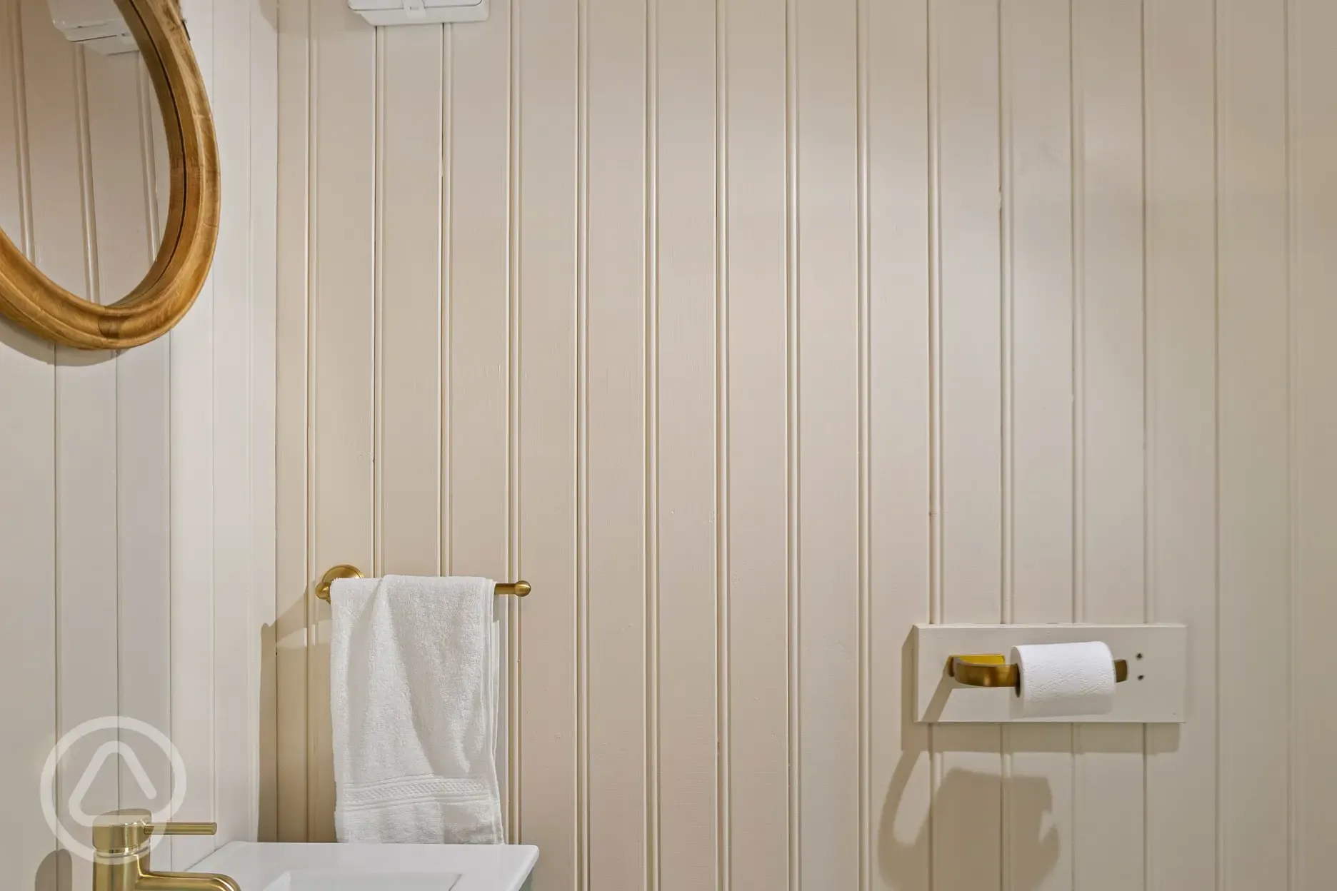 Shepherd's hut facilities with toilet, sink and mirror