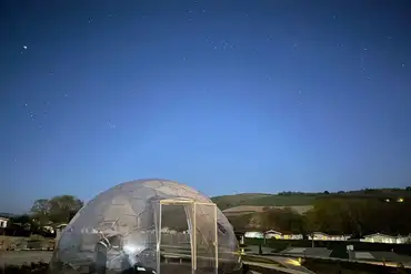 Communal stargazing dome with a telescope at night