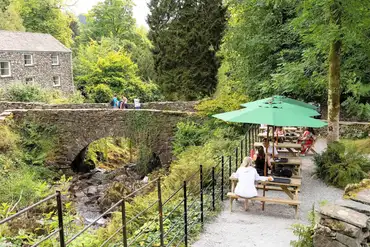 Onsite tea room and cafe with outdoor seating by the stream