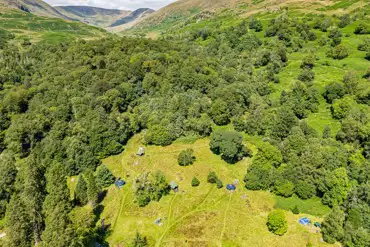 Birdseye view of non electric grass pitches and the distant Lake District