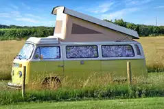 Grass pitches with small campervans welcome