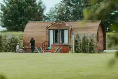 Ensuite lodge cabin with a wood-fired hot tub and a patio