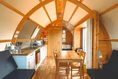 Lodge interior featuring a kitchenette, a dining area, and convertible sofa beds