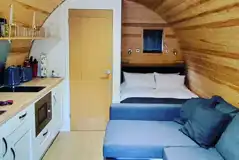 Luxury Cedar Pod interior featuring a double bed and kitchenette at Shays Farm