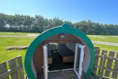 Wooden camping pod with a gated garden area