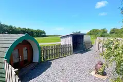 Wooden camping pod with a gated garden area and chimenea