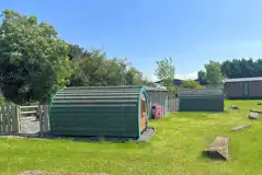 Wooden camping pods with gated garden areas