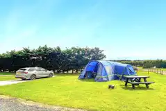 Electric hardstanding and grass touring pitches (12m x 6m)