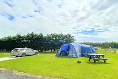 Electric hardstanding and grass touring pitches (12m x 6m)