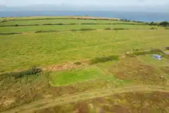 Electric grass pitches overlooking the Wales coastline