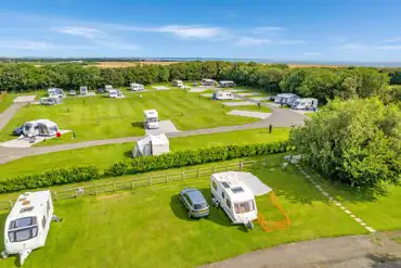 Aerial of grass and hardstanding touring pitches