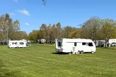 Caravans on the optional electric grass pitches at Caravan Park at Stanford Hall