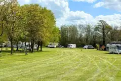 Grass pitches set around trees with an optional electric 16 amp hook up