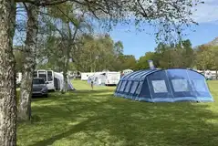 Large tents and tourers on the optional electric grass pitches