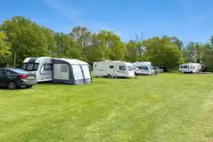 Grass pitches (6m x 10m) with space for a parked car