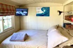 Shepherd's hut double bed and TV