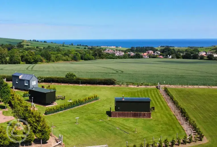 Aerial of the glamping area and sea views