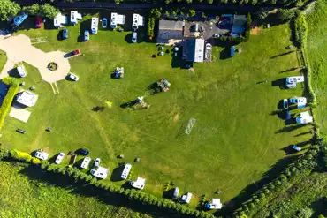 Bird's eye view of The Barn Caravan Park with hedges borders
