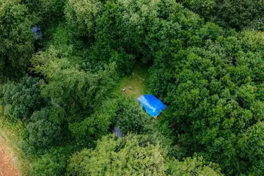 Aerial of the grass pitches, set amongst the trees