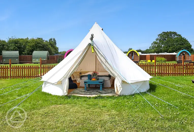 Bell tent with a picnic bench at The Pretty Thing