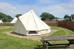 Regular bell tent with a picnic bench