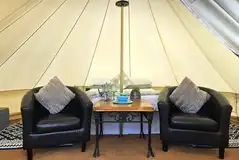 Regular bell tent with a double bed and arm chairs Regular bell tent with a double bed and arm chairs