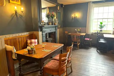 Woodbridge Inn pub indoor seating area with fireplace