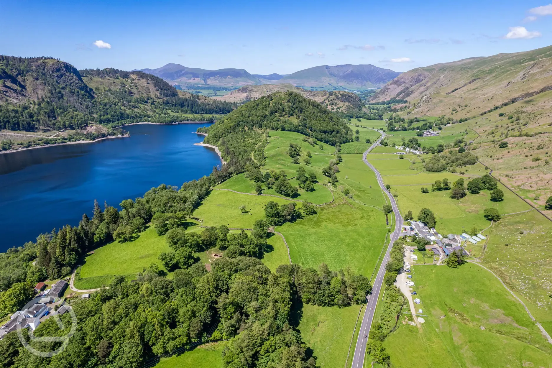 Aerial of Thirlspot Farm Camping with views of mountains and Thirlmere Reservoir