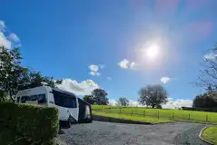 Fully serviced hardstanding pitches surrounded by hornbeam hedging for privacy