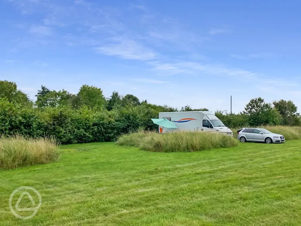 Grass pitches tucked behind long grass banks for added privacy