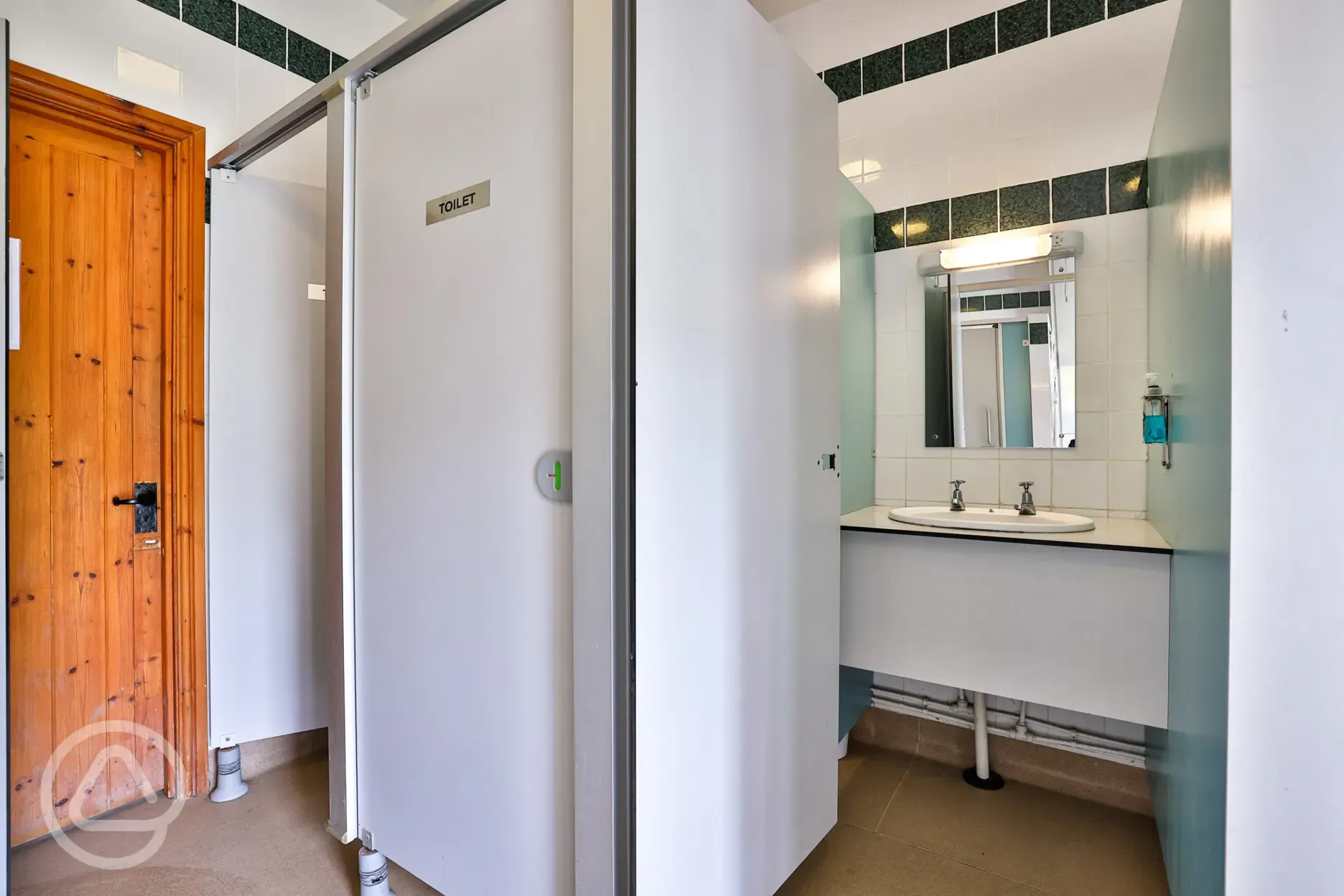 Communal toilets cubicles with sinks and mirrors