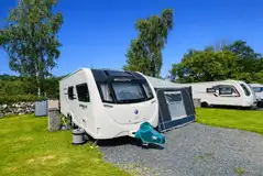 Electric hardstanding pitches (half gravel and half grass) measuring 10m by 8m